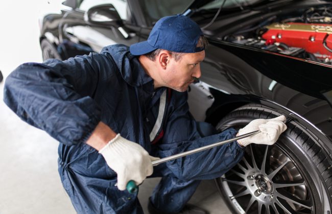 Sports car in a workshop Sports car in a service workshop - fixing a dent